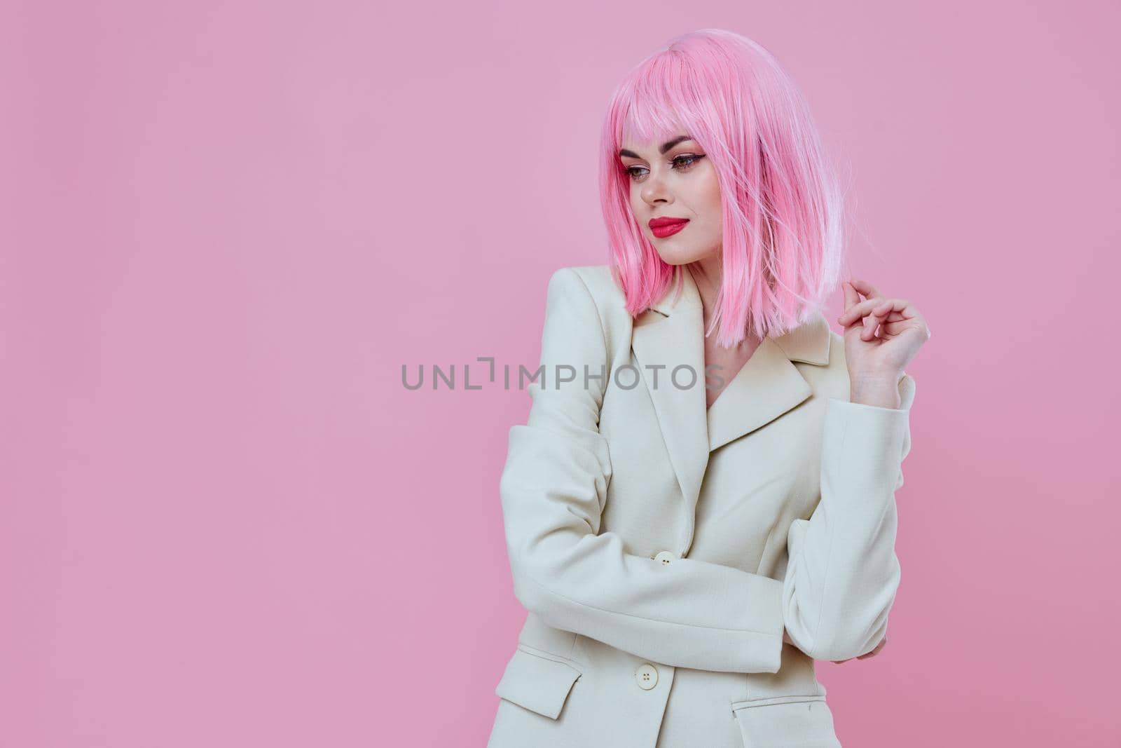 Young woman in White blazer pink hair Glamor Cosmetics pink background unaltered. High quality photo