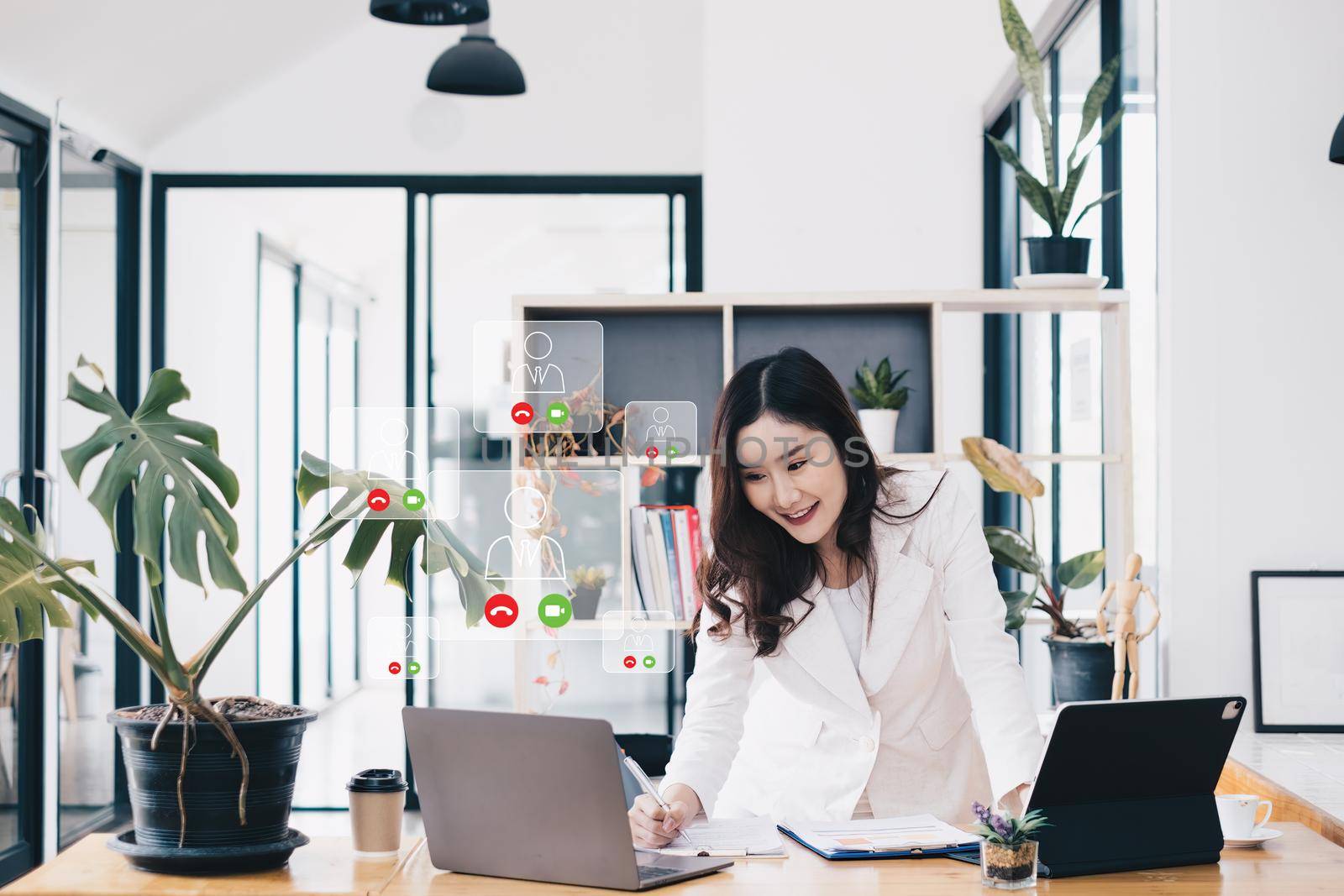 Asian business woman having video call with business team to consult about business plan of company. Online team meeting video conference