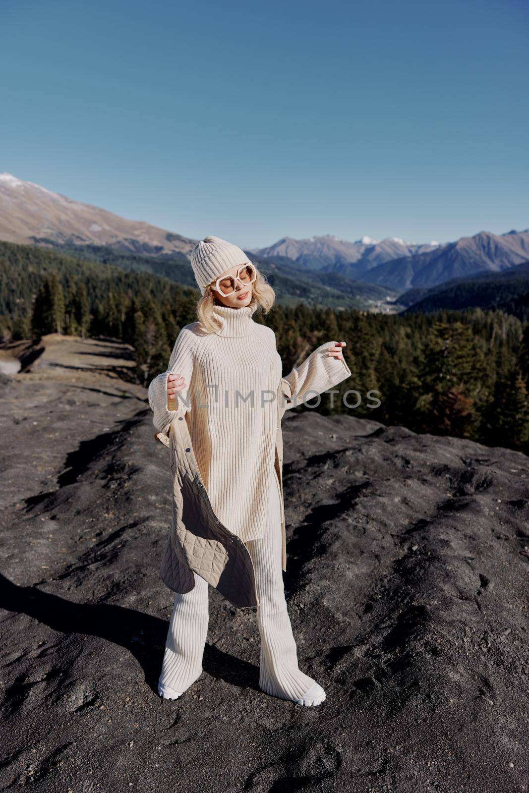 young woman fashion glasses mountain top nature freedom relaxation. High quality photo