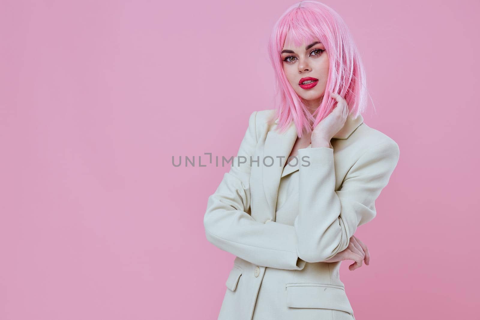 Portrait of a charming lady in White blazer pink hair Glamor Cosmetics pink background unaltered. High quality photo