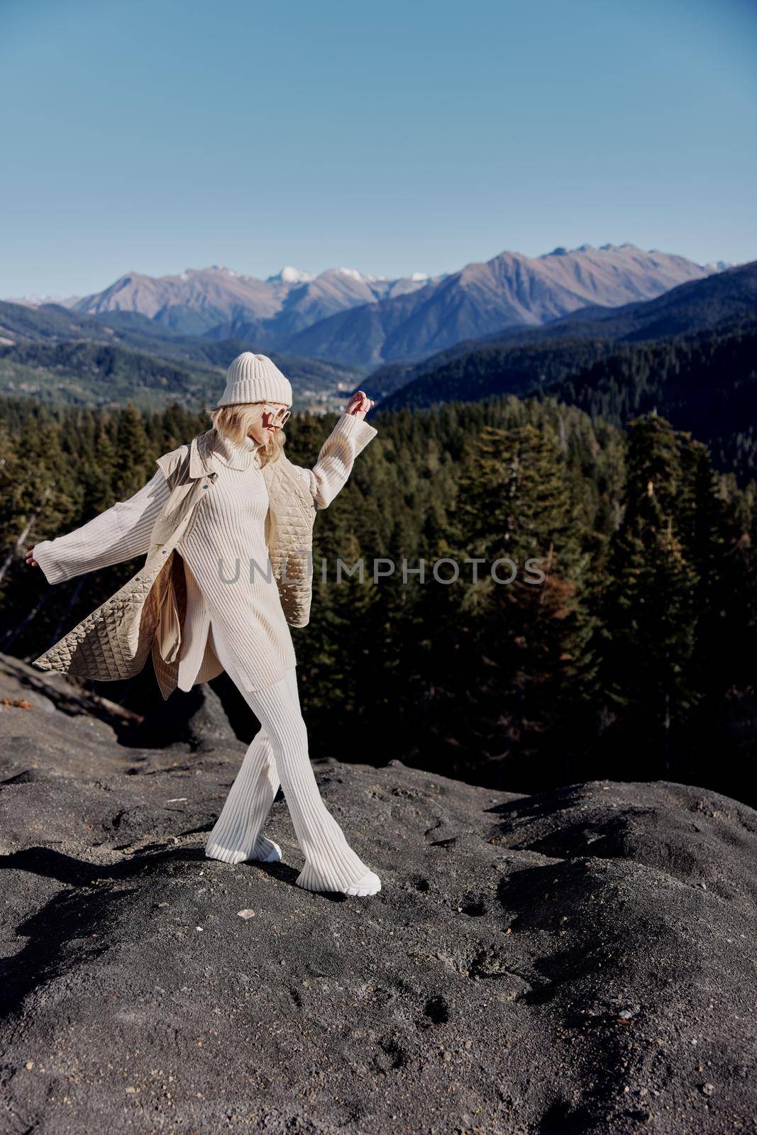 young woman fashion glasses mountain top nature freedom landscape. High quality photo