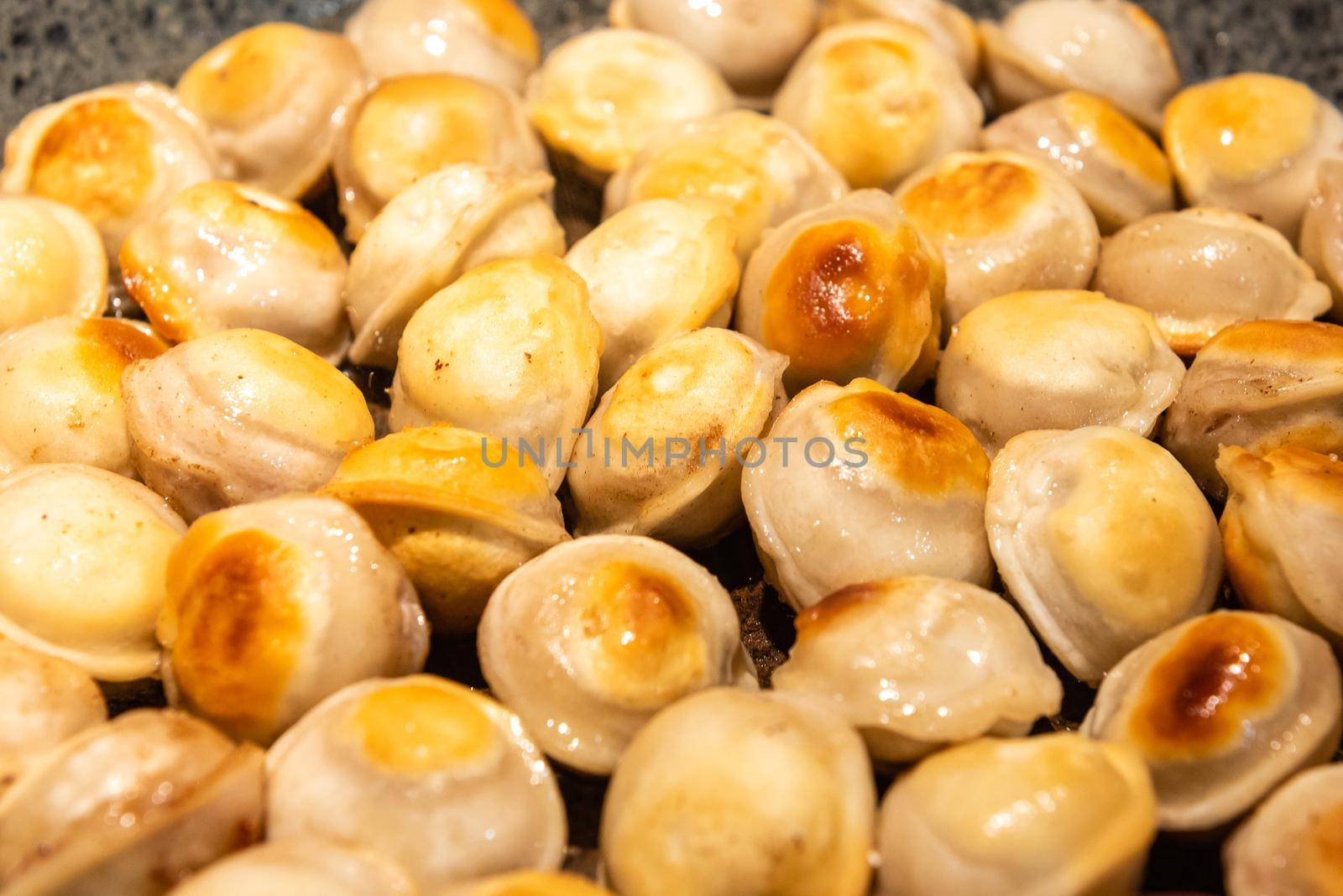 Fried meat dumplings fried on the pan. traditional russian cusine.