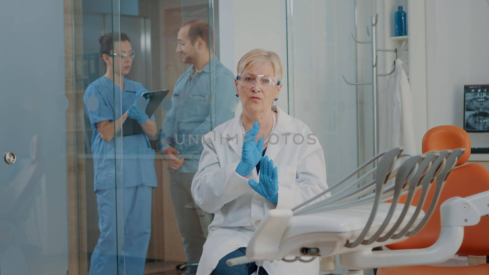 POV of dentistry expert using online video call to give stomatological advice to patient on remote communication. Senior dentist explaining oral care on video teleconference call.