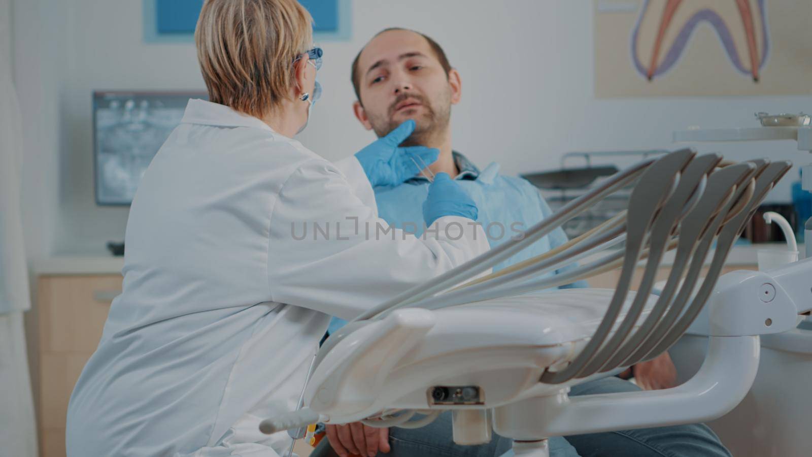 Dentistry expert using dental tools to examine cavity problems and to treat patient with toothache. Dentist doing oral care consultation with stomatology instrument at checkup visit.