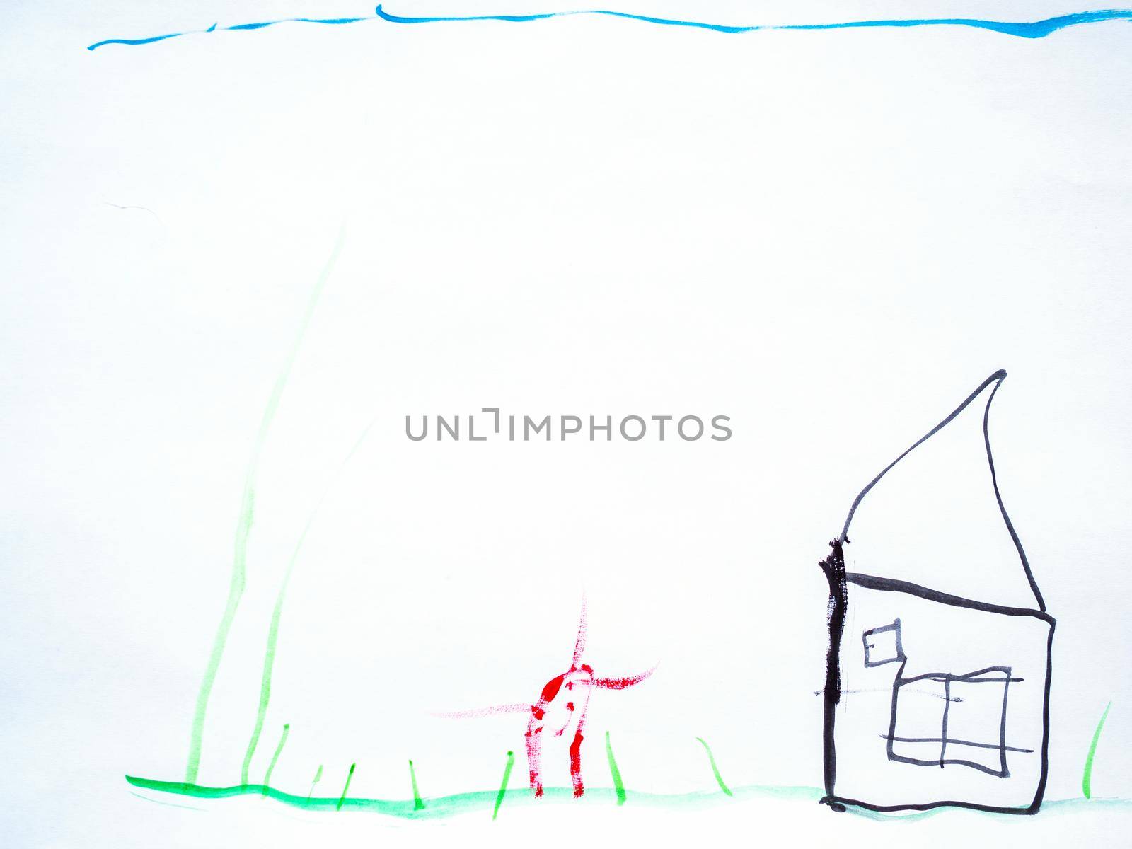 Wman's hand with the pencil drawing the dream home on a white sheet of paper