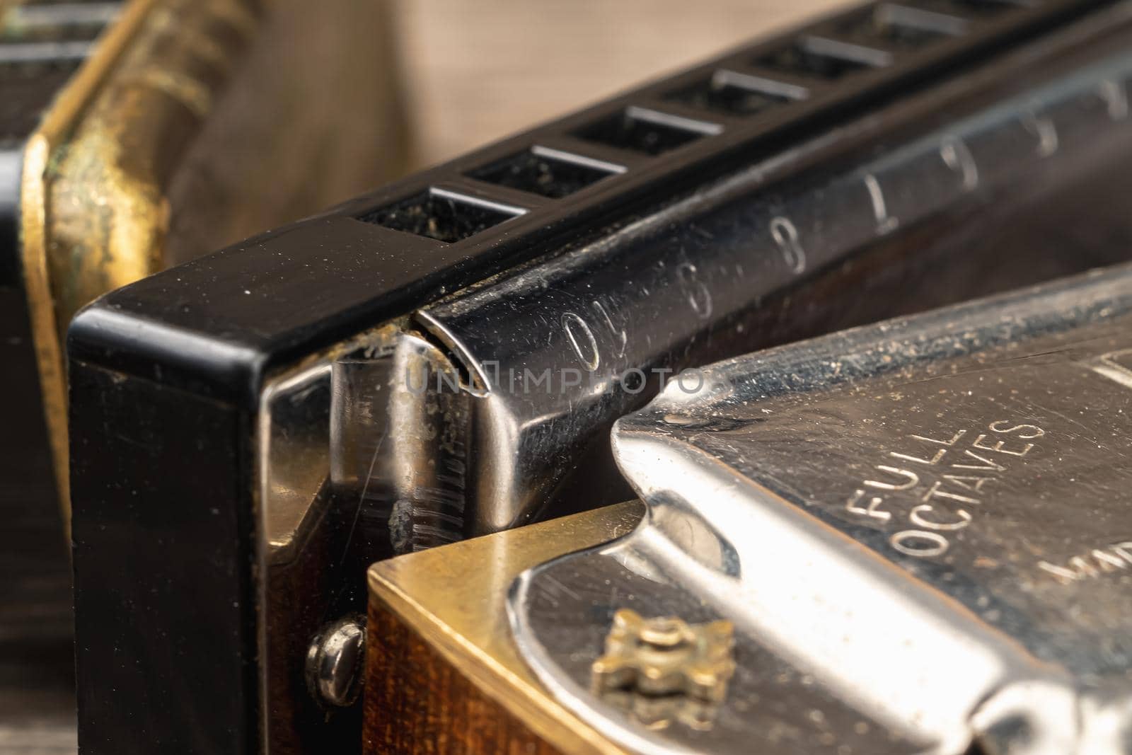 musical instruments vintage harmonics diatonic and chromatic on old wooden desk. world music day. Horizontal orientation.