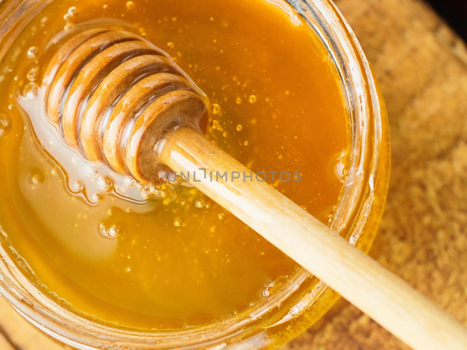 honey with wooden mixer top left view.