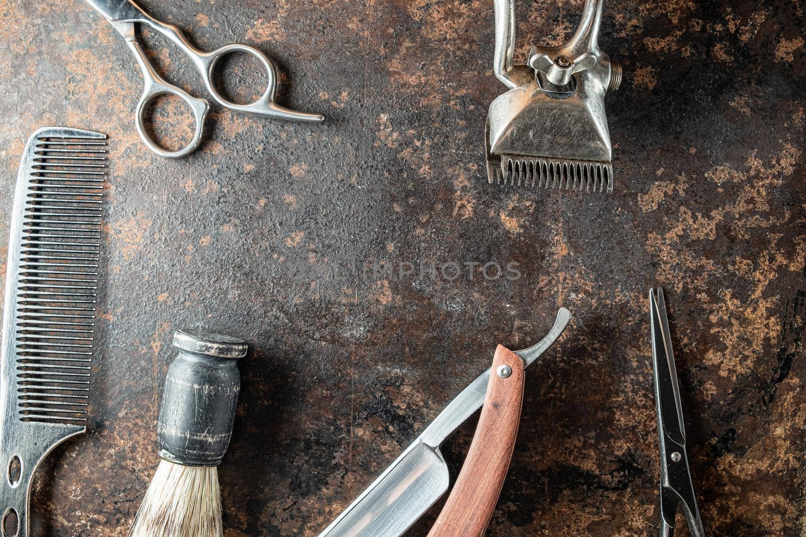 vintage barber tools dangerous razor, hairdressing scissors, old manual clipper, metal comb, shaving brush. old rusty metal background. Horizontal. top view, flat lay.