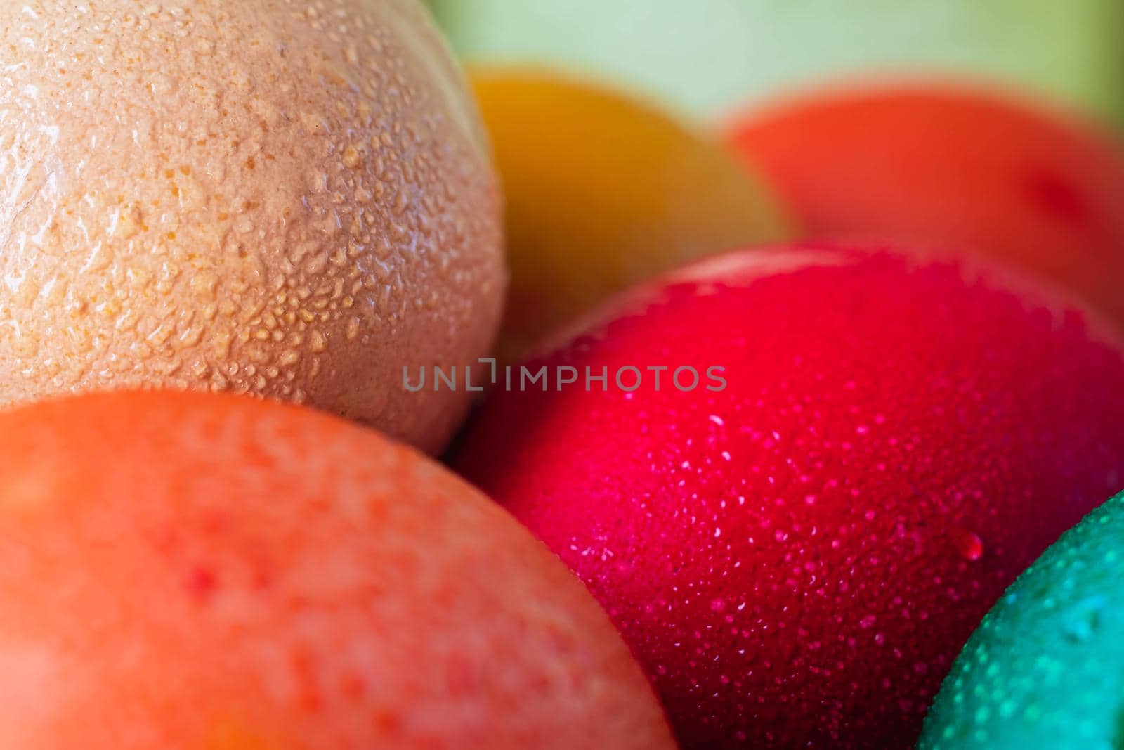 still life of a variety of colored Easter eggs in rustic style blur background. horizontal orientation