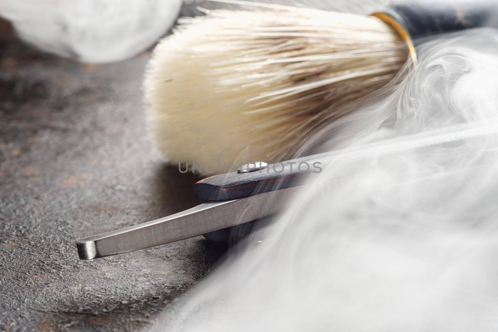 On a rusty surface are old hairdresser tools. razor, shaving brush, comb. close up. rustic. horizontal orientation. copy space. steaming tools.