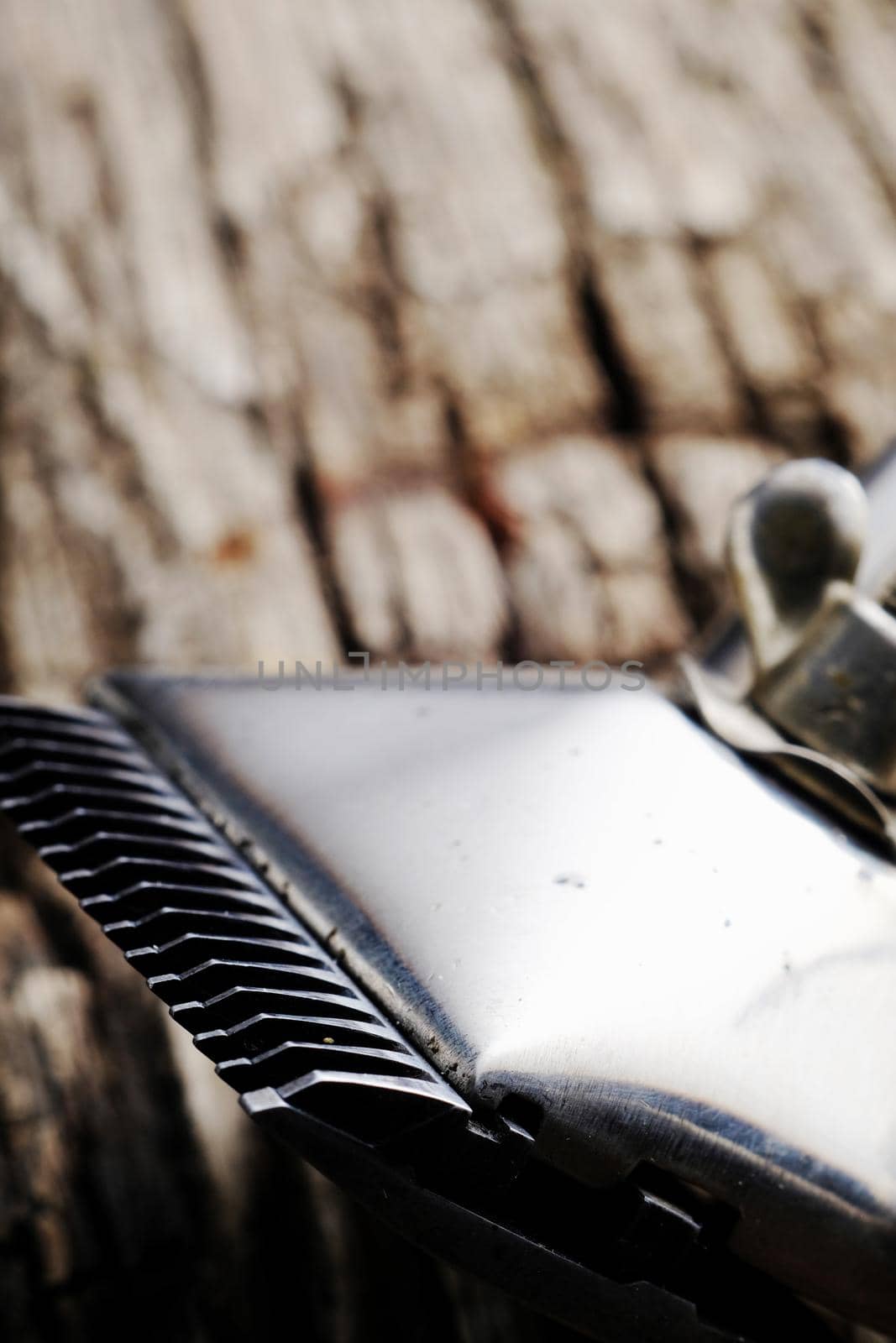 On a old wooden surface are old barber tools. Vintage manual hair clipper. vertical orientation.