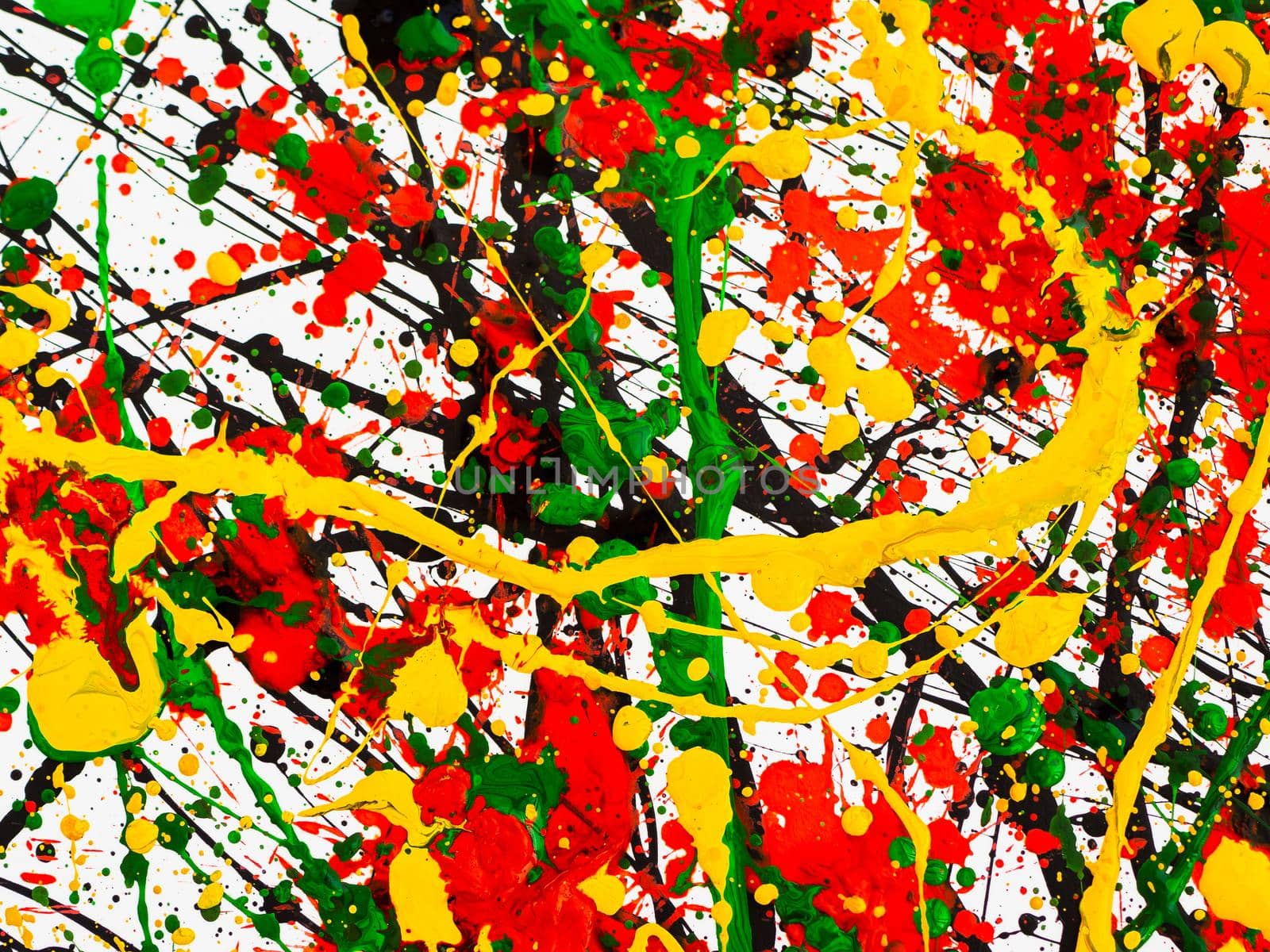 an abstraction with splashes of black and red and green and yellow paint on a white background