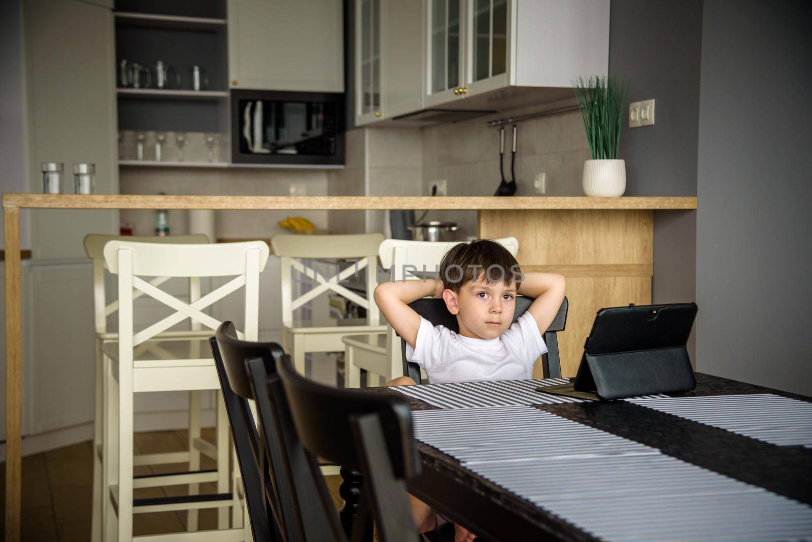 Toddler staring at tablet. Education, gadget, dependency, technology, addiction child eyesight raising children concept.