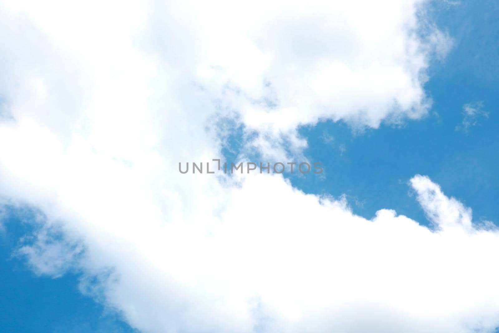 Beautiful white clouds in the blue sky. The background of nature