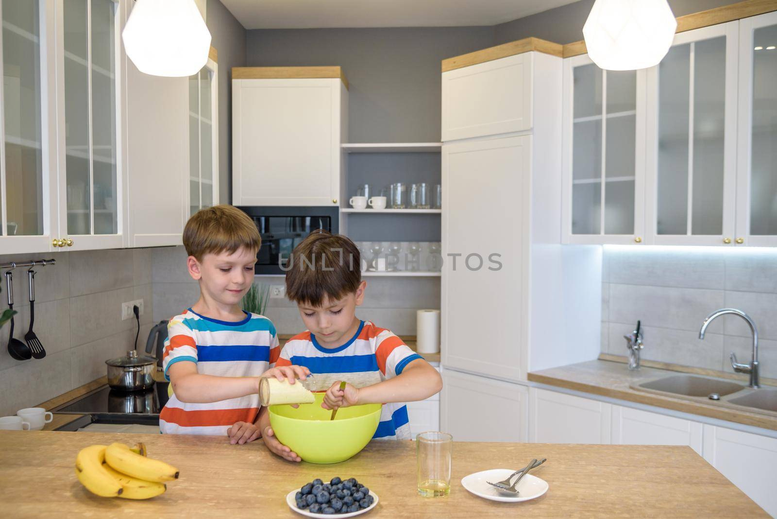 happy family funny kids are preparing the dough, bake cookies in the kitchen.