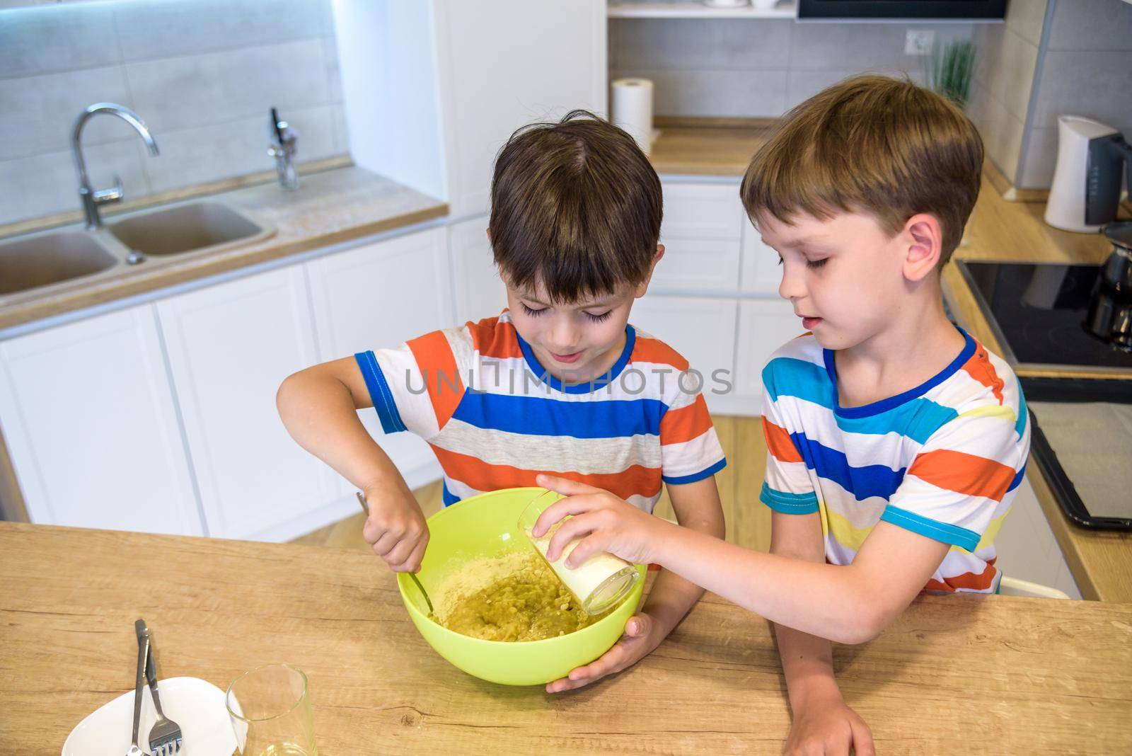 happy family funny kids are preparing the dough, bake cookies in the kitchen.