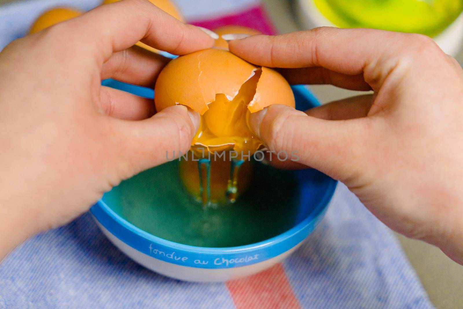 hands cracking an egg for some kind of recipes by CatPhotography