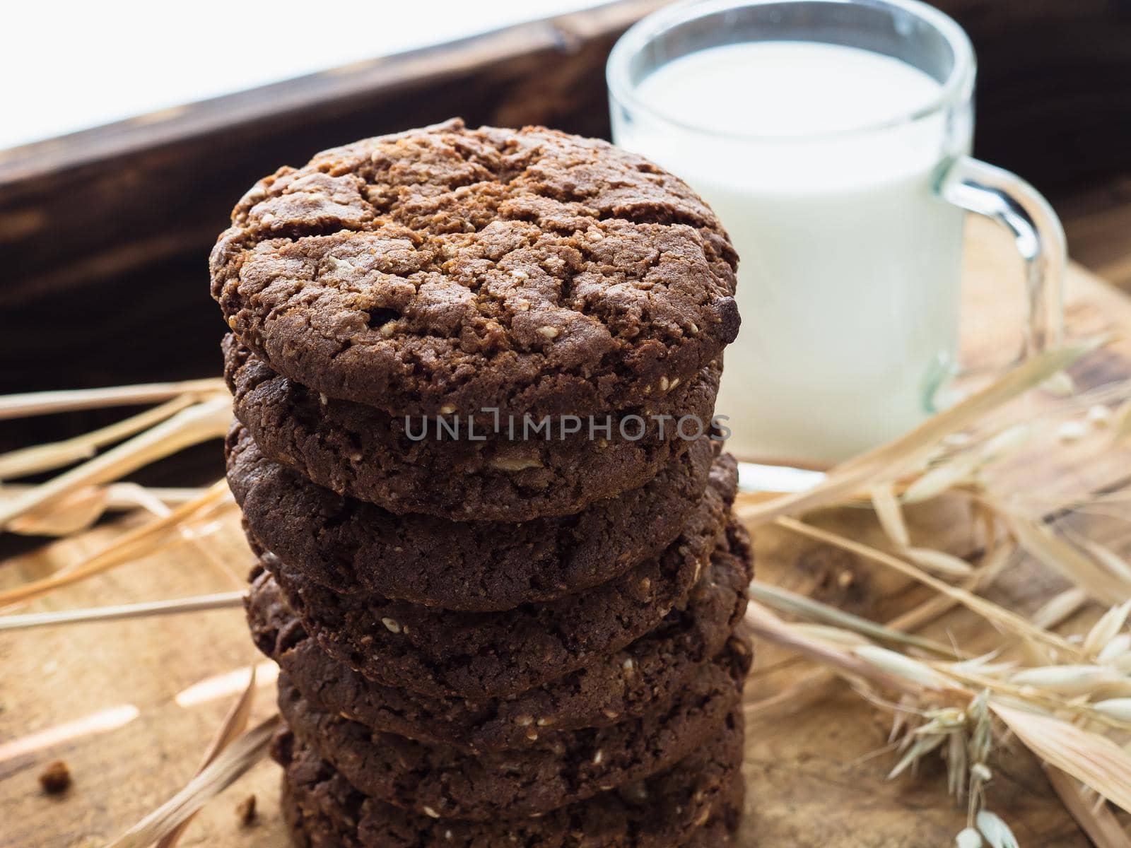 oatmeal cookies oats and milk on a wooden background.