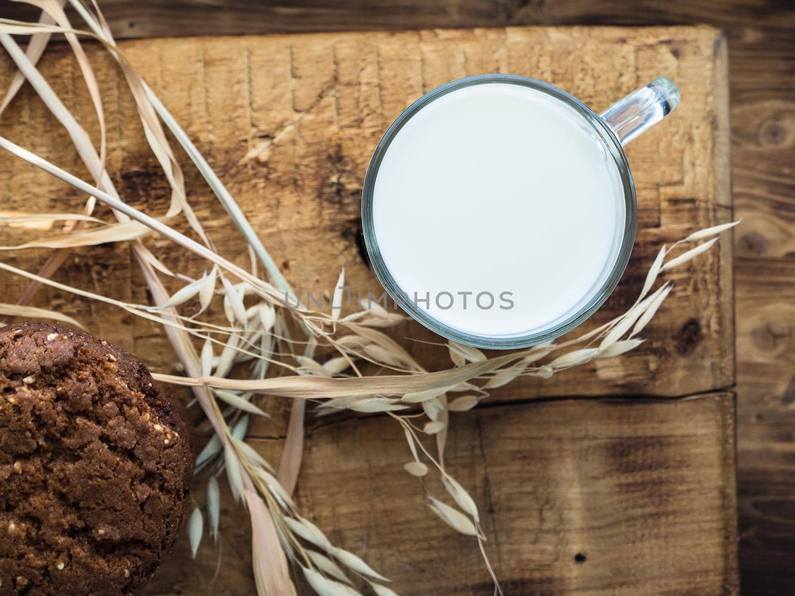 oatmeal cookies oats and milk on a wooden background.
