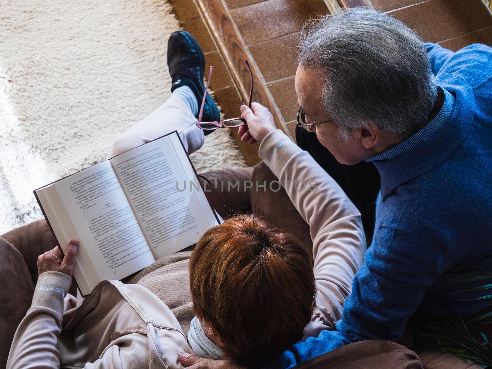 Marriage reading a book in a traditional house by CatPhotography