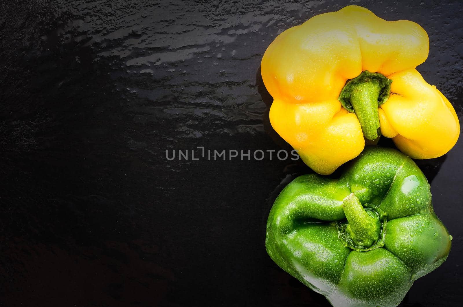 two sweet pepper on slate yin yang place on the left. top view
