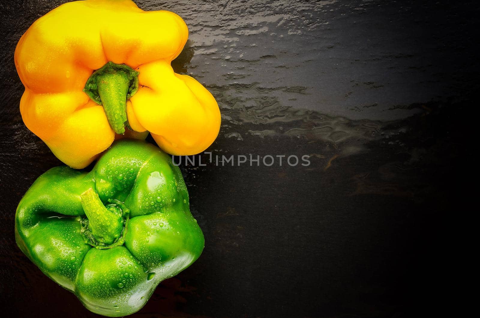 two sweet pepper on slate yin yang place on the right. top view