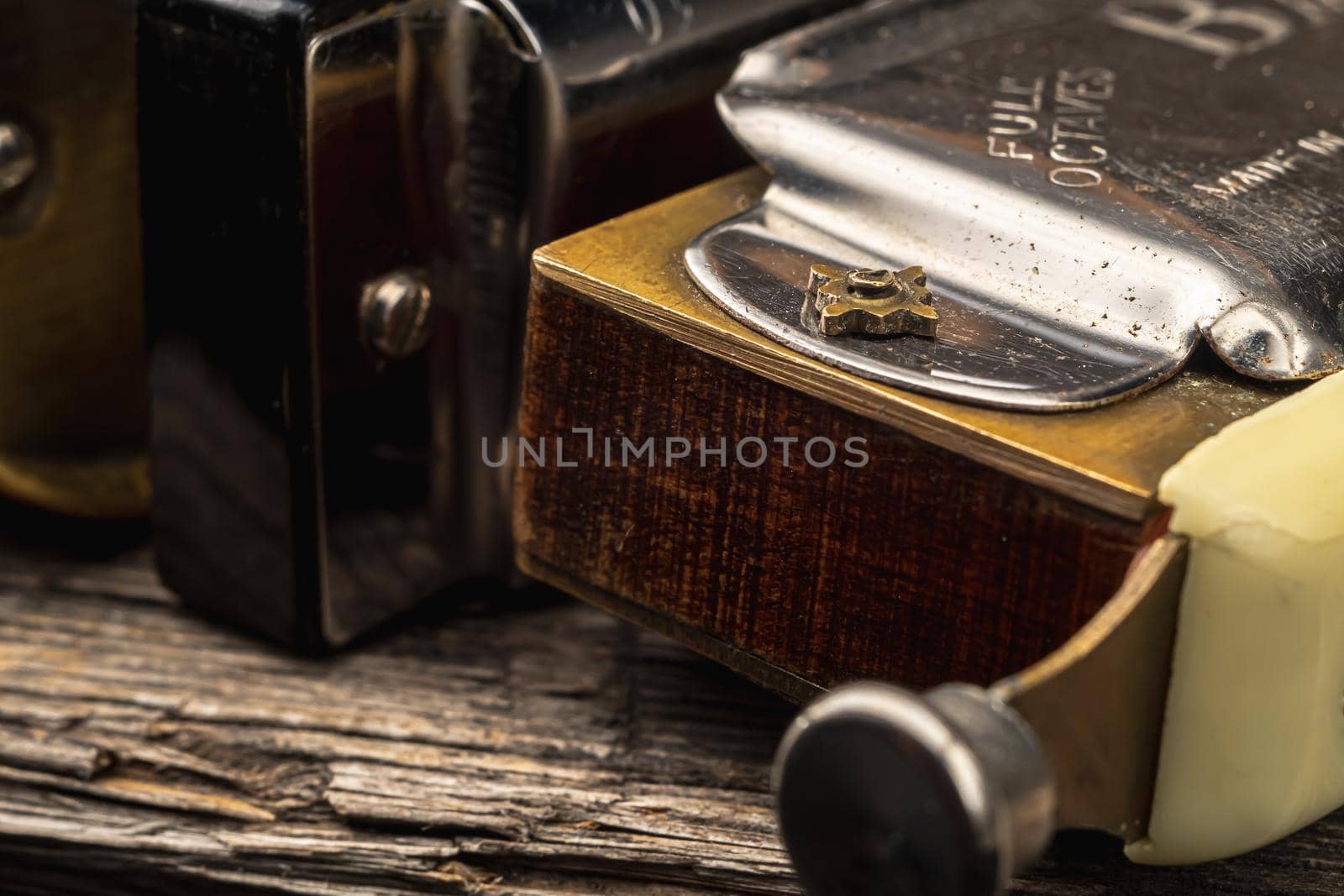 musical instruments vintage harmonics diatonic and chromatic on old wooden desk. world music day. Horizontal orientation.