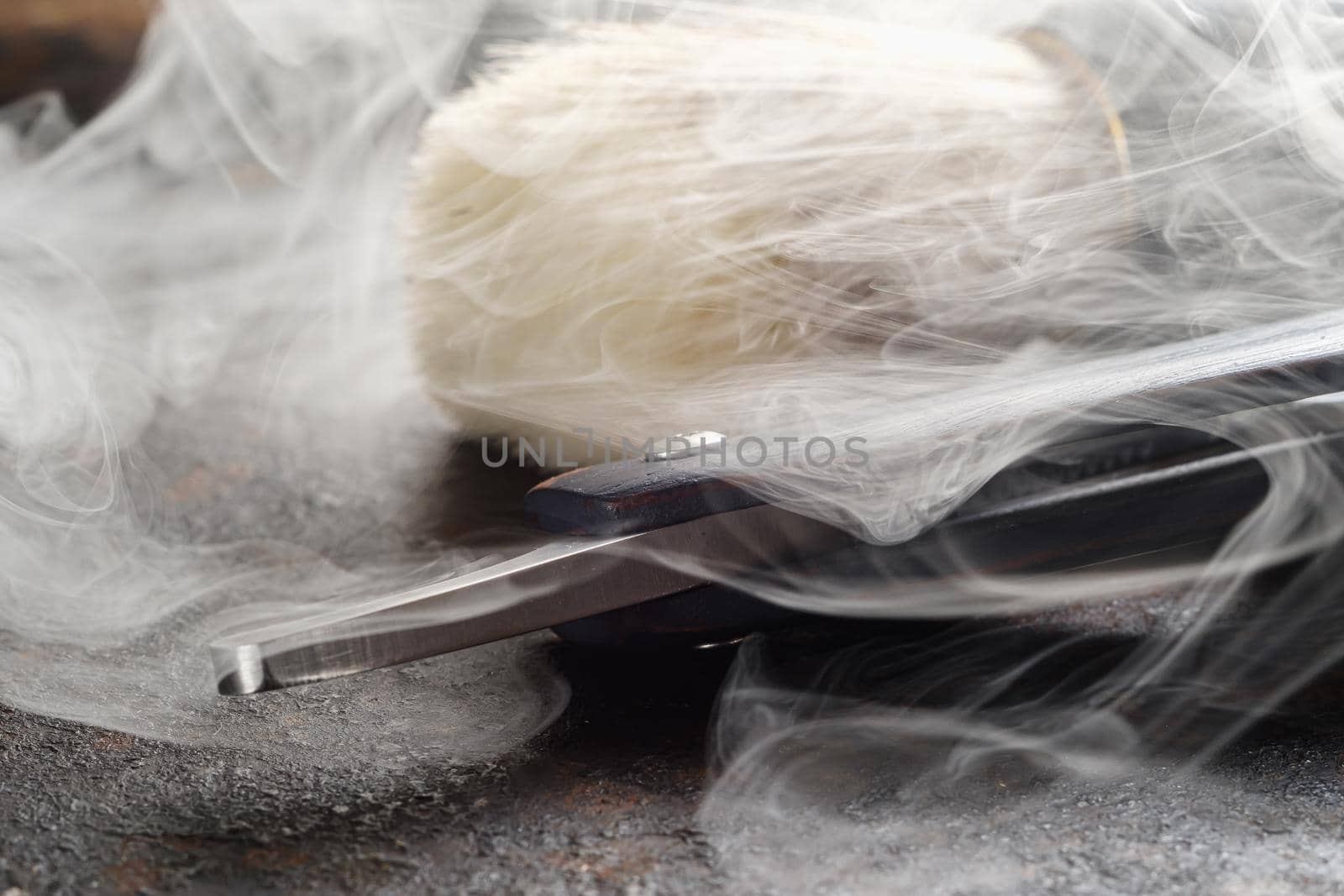 On a rusty surface are old hairdresser tools. razor, shaving brush, comb. close up. rustic. horizontal orientation. copy space. steaming tools.