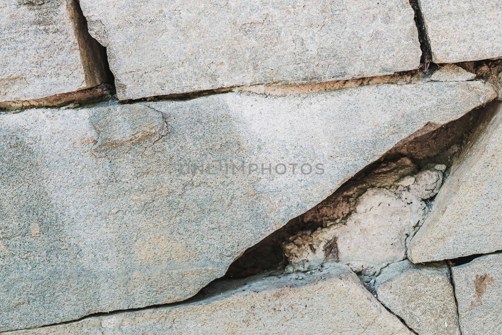 The ancient rusty old masonry stone texture for background and design concepts. the shadow. geology. Horizontal background