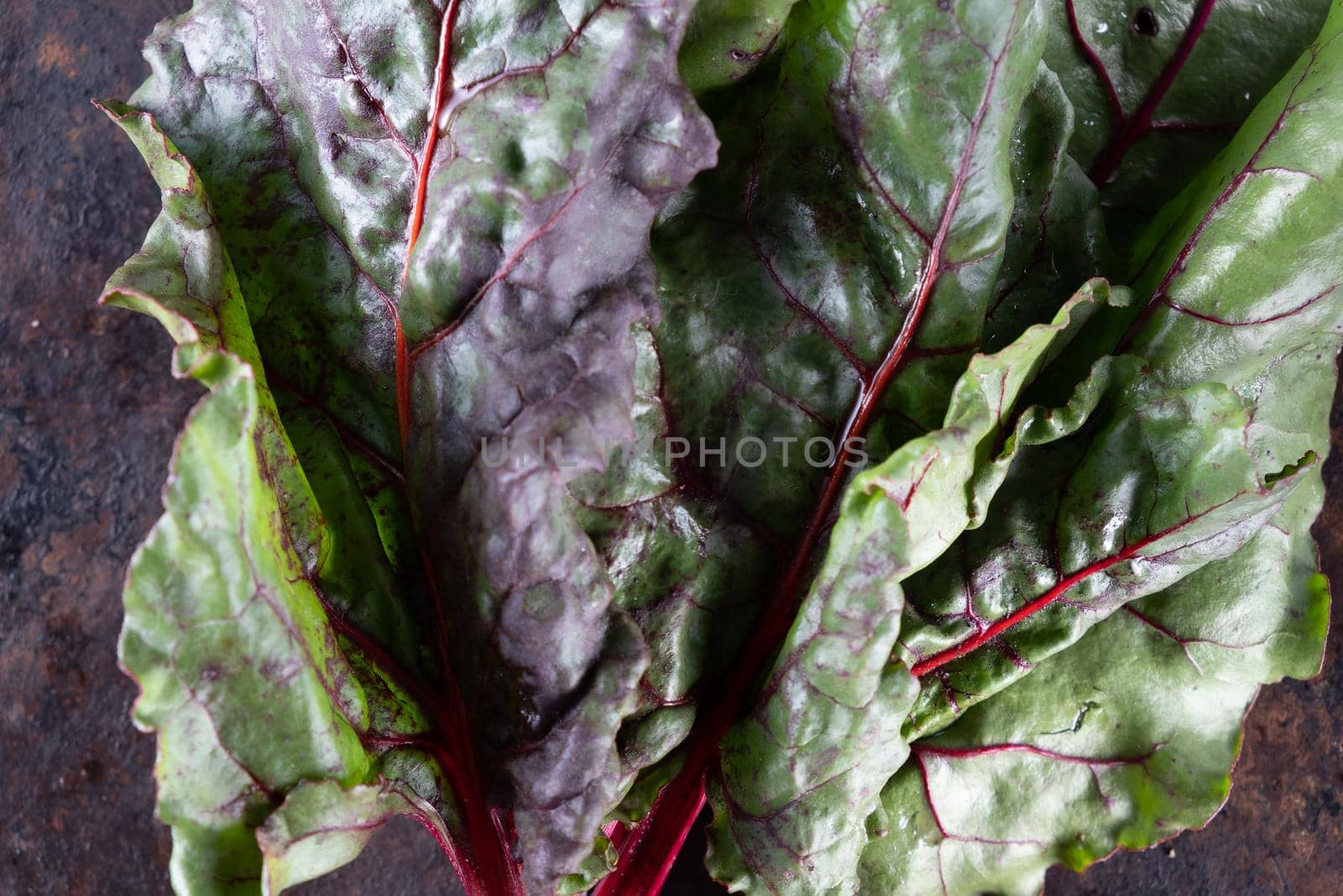 ugly food. Beets and beet leaves on a rusty beautiful metal surface. close-up. horizontal orientation. flat lay. top view.