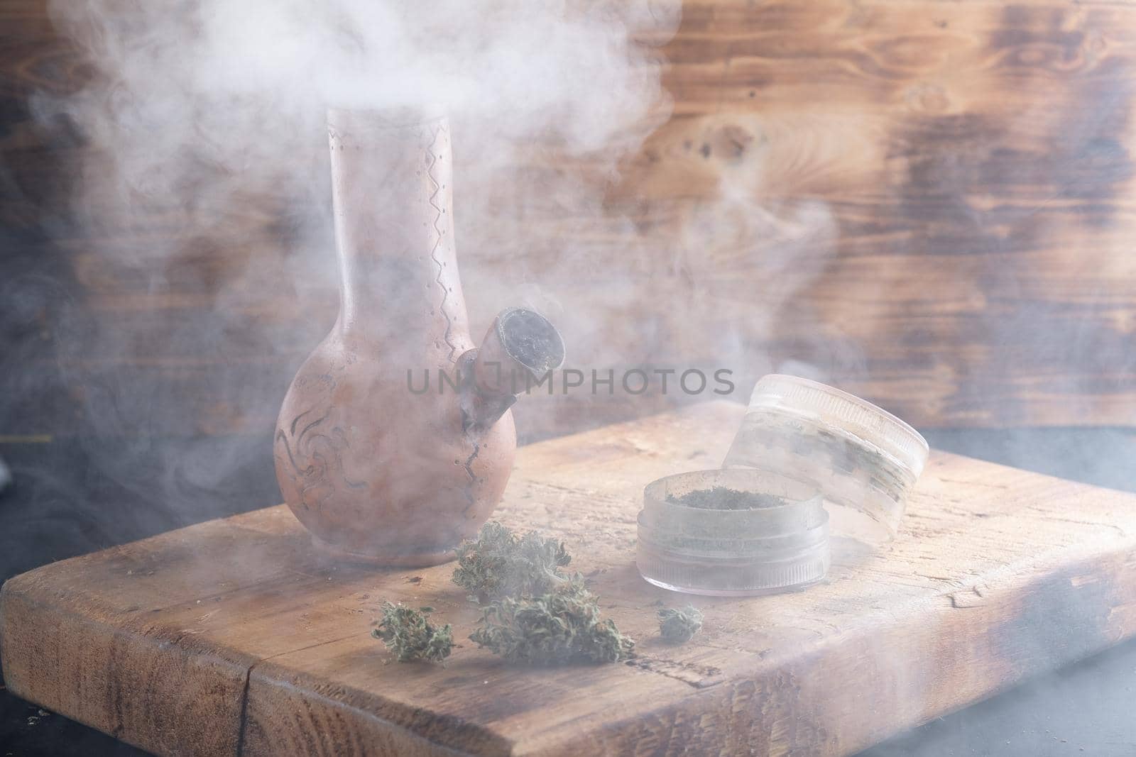 bong and open grinder cannabis and marijuana in smoke by Alexander_V
