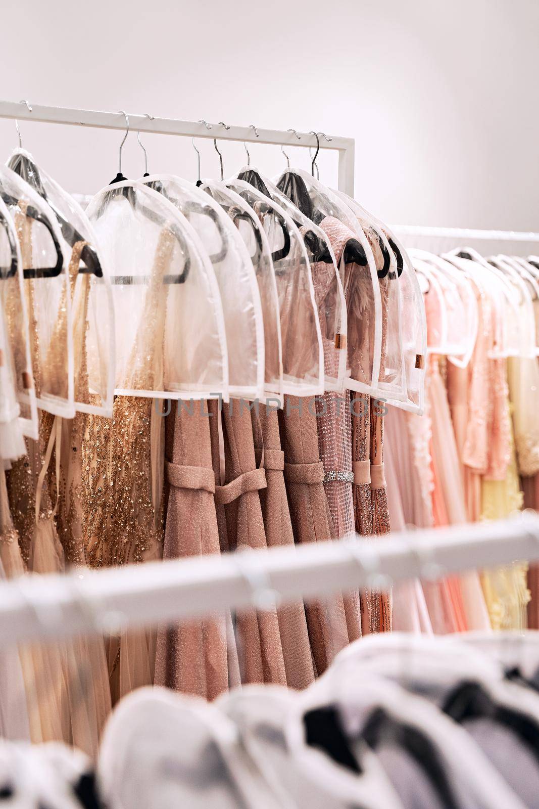 Different dresses in different colors on hangers in a rental service