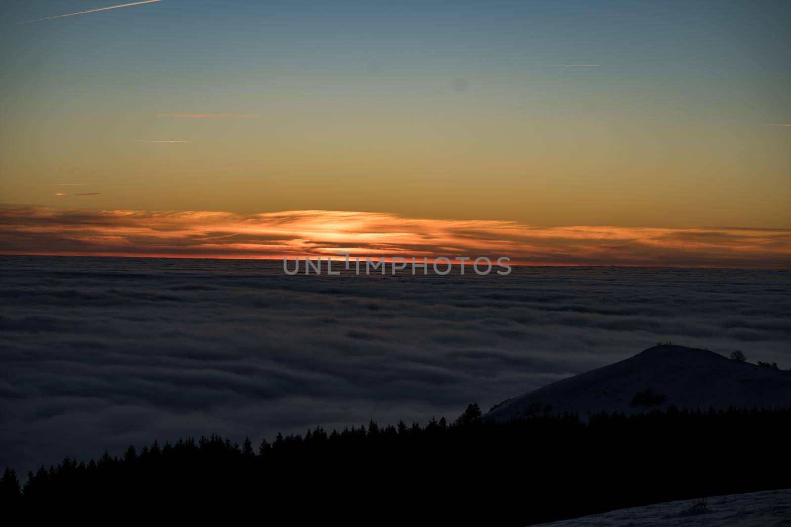 the romance of tourism and recreation, as well as the principles of a healthy lifestyle, is to watch the fantastic play of the sun's rays setting over the horizon on the highest Wasserkuppe mountain in Hesse, Germany and breathe the fresh, clean mountain air. High quality photo