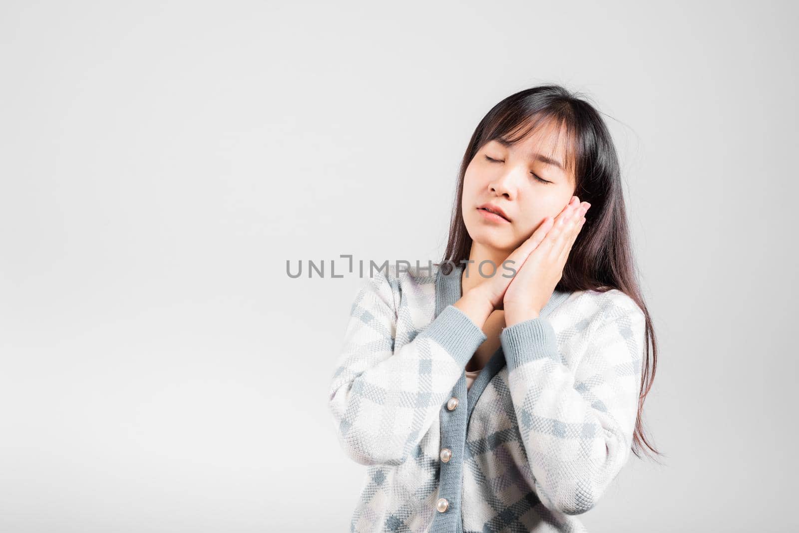 Sleep woman pretended emotions sleeping tired eyes closed dreaming with hands together near face, Portrait Asian beautiful young female sleep studio shot isolated on white background with copy space