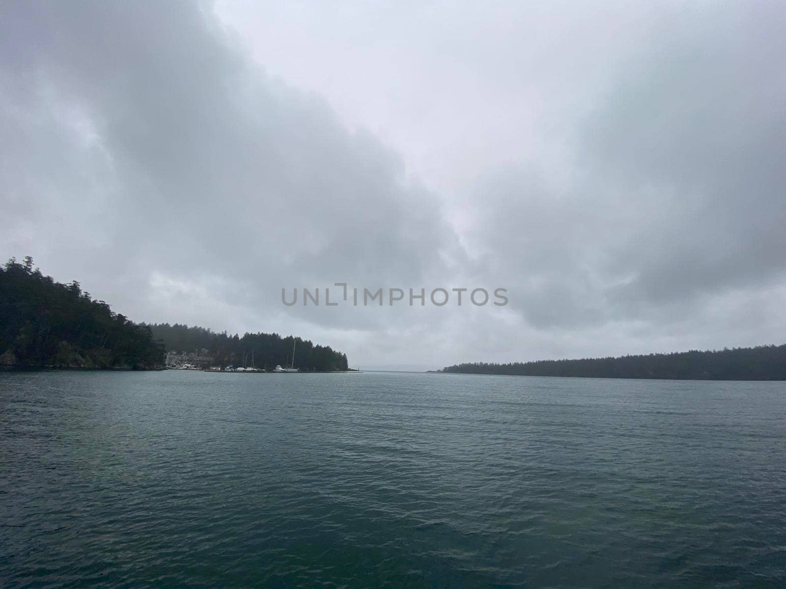 Grey skies over mountains and ocean by Granchinho