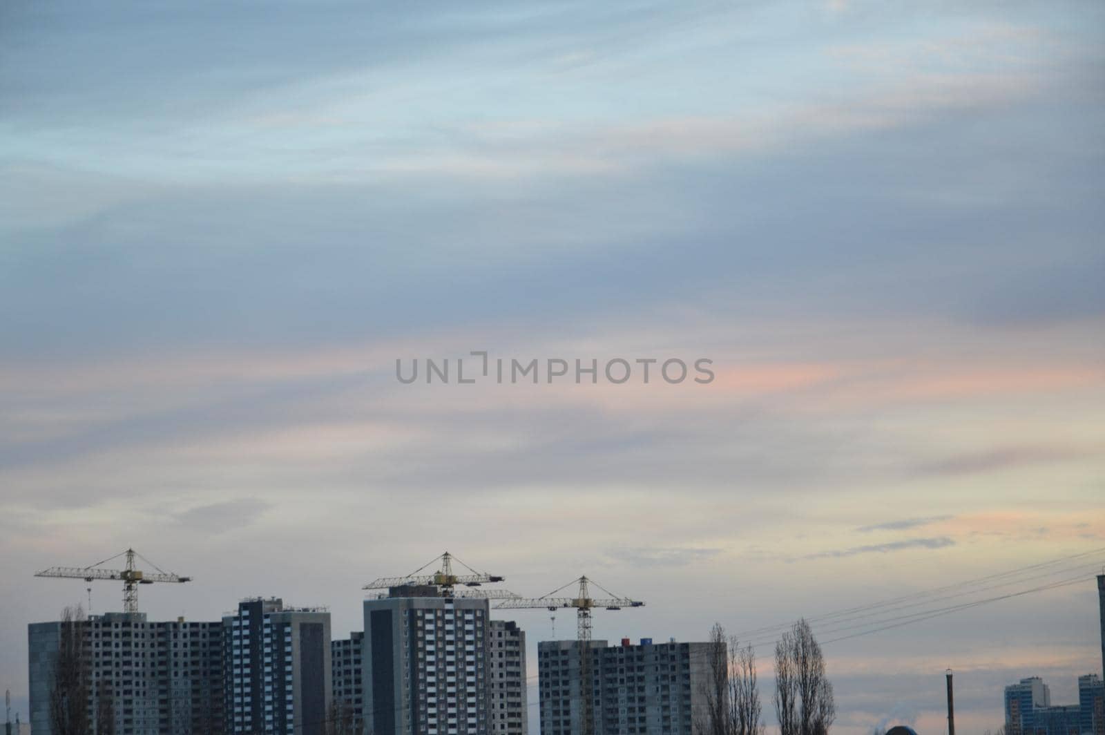 New buildings against the backdrop of a pink clouds in the city