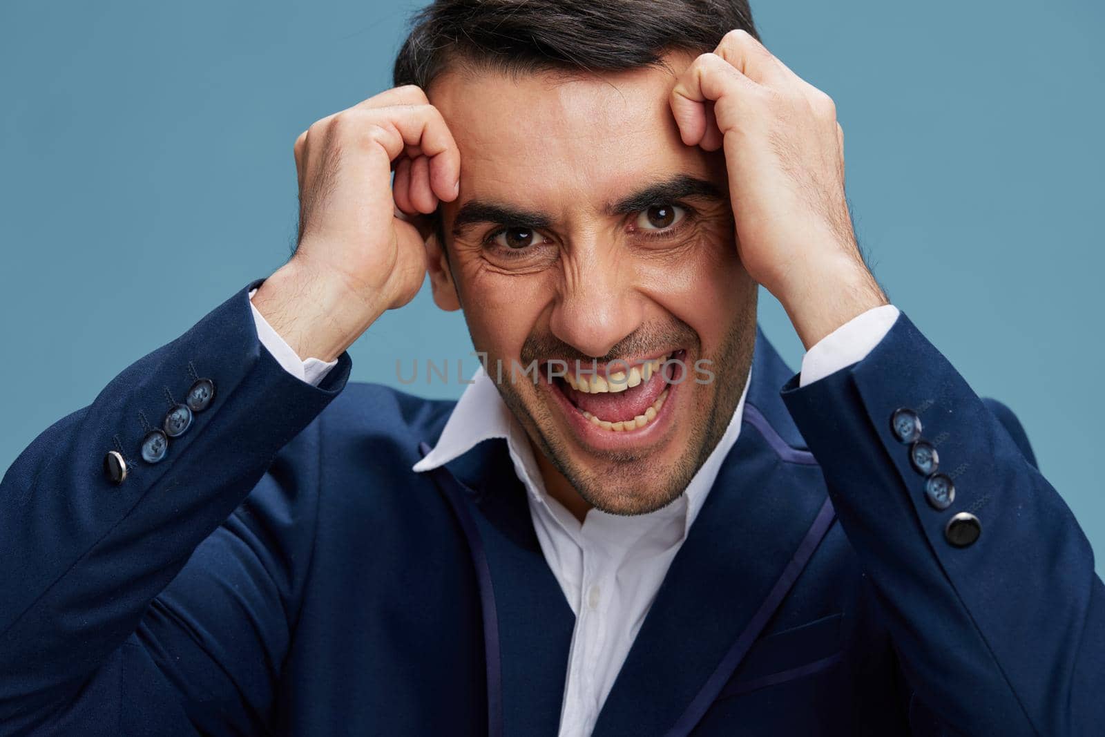 business man holding his head emotional breakdown headache and closeup blue isolated background Copy space by SHOTPRIME