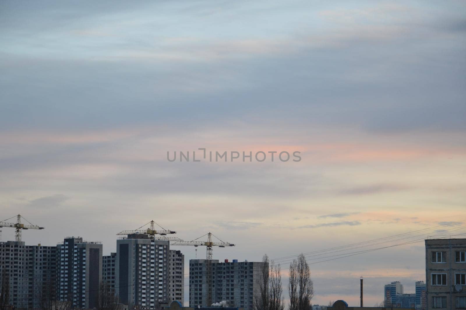 New buildings against the backdrop of a pink clouds in the city