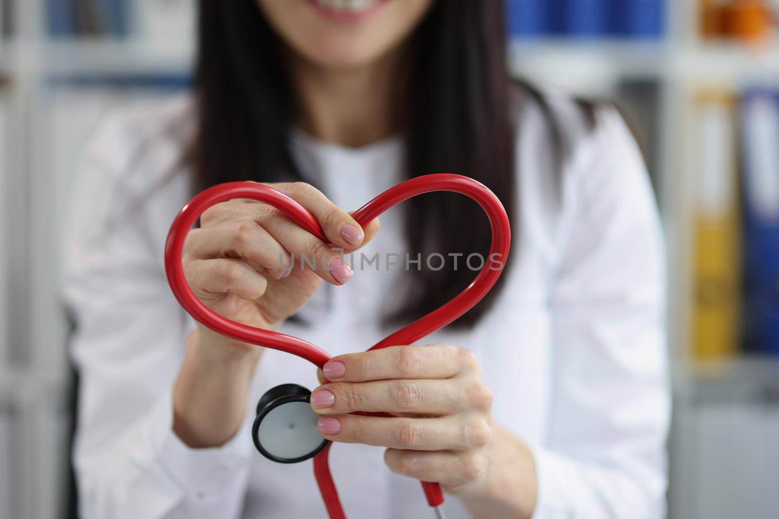 The doctor folded the figure of the heart from a stethoscope, close-up. Cardiovascular diseases, prevention