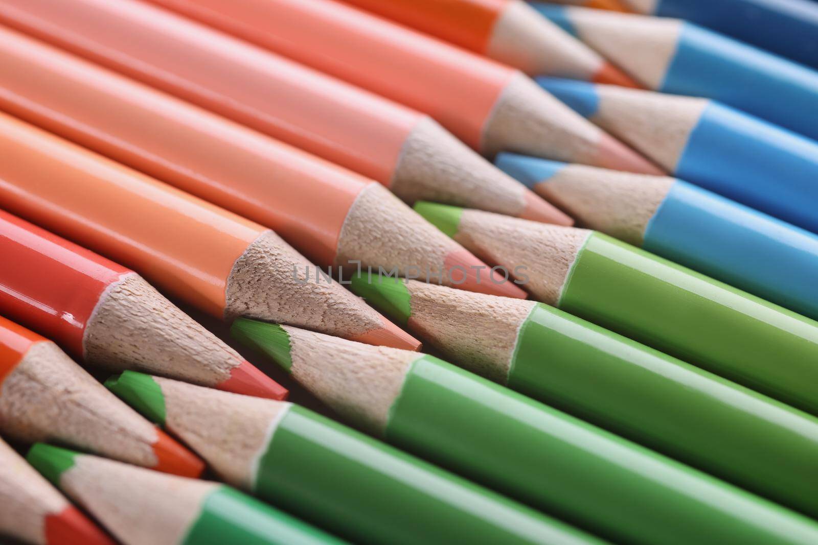 Macro sharpened red green blue pencils, close-up. Colored graphite rod, education, creativity, fine arts