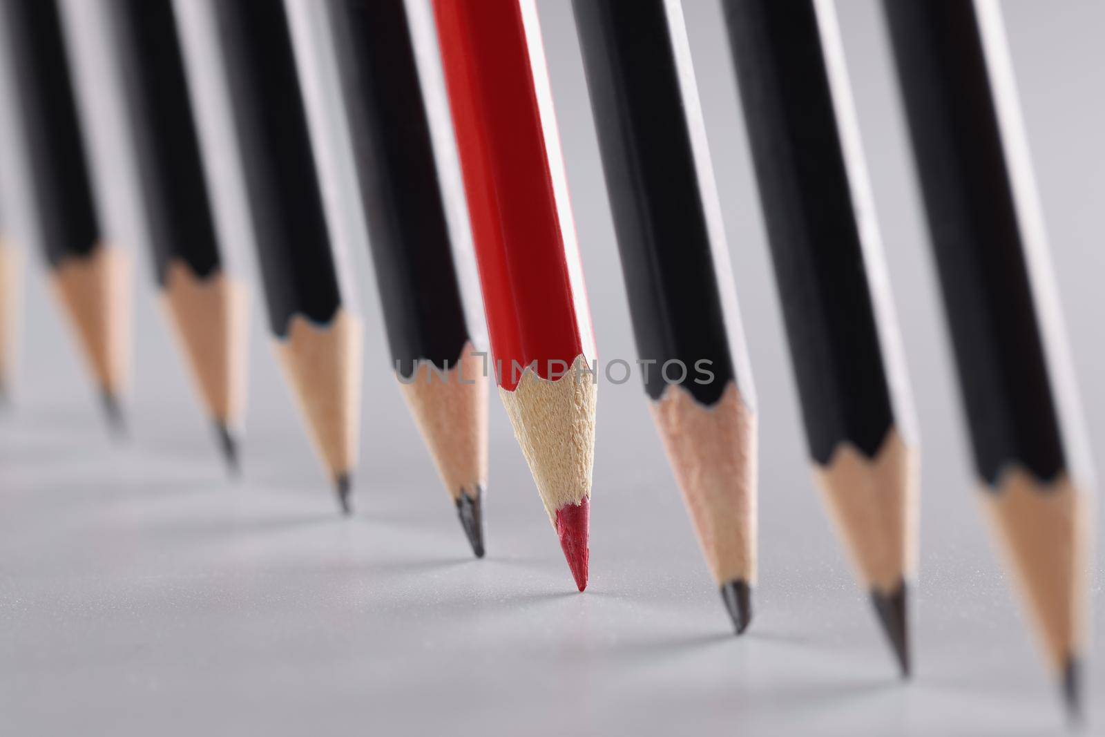 Sharp pencils in a row on a gray background by kuprevich