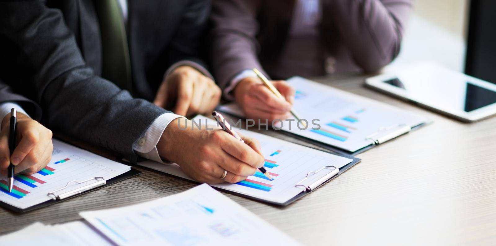Banking business or financial analyst desktop accounting charts, pens indicates graphics