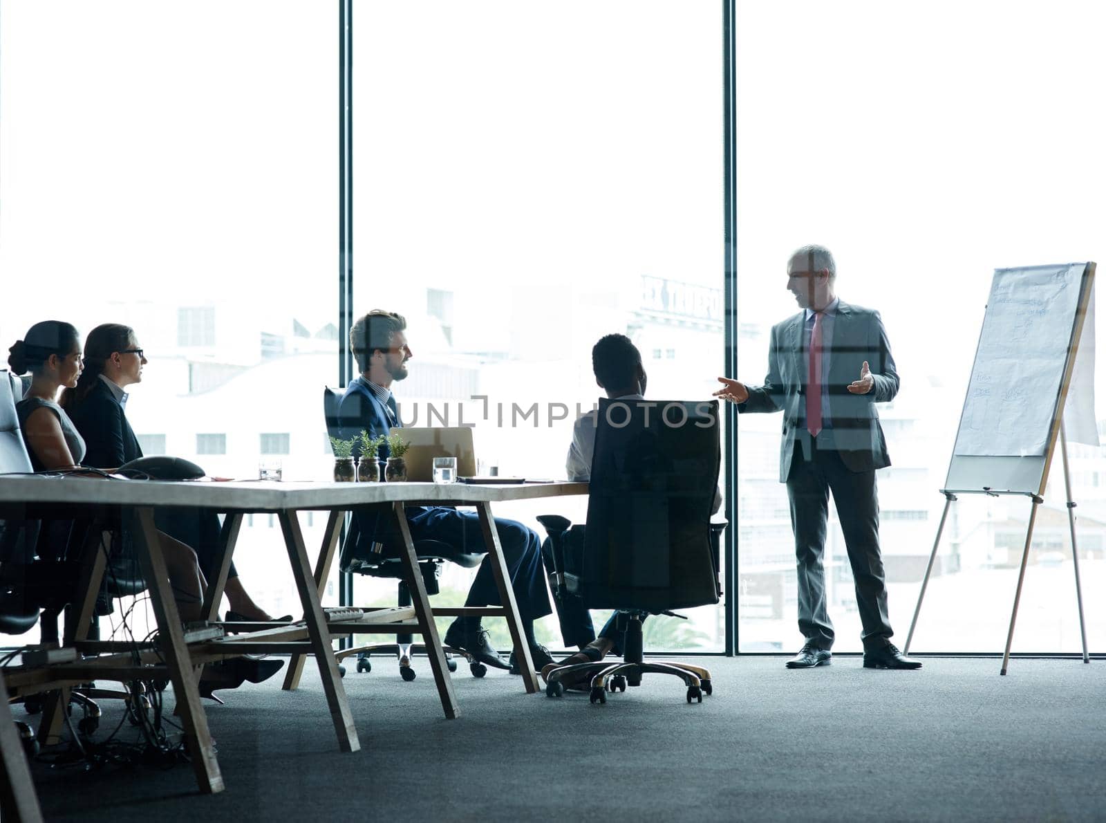 Shot of a group of executives having a meeting in a boardroom