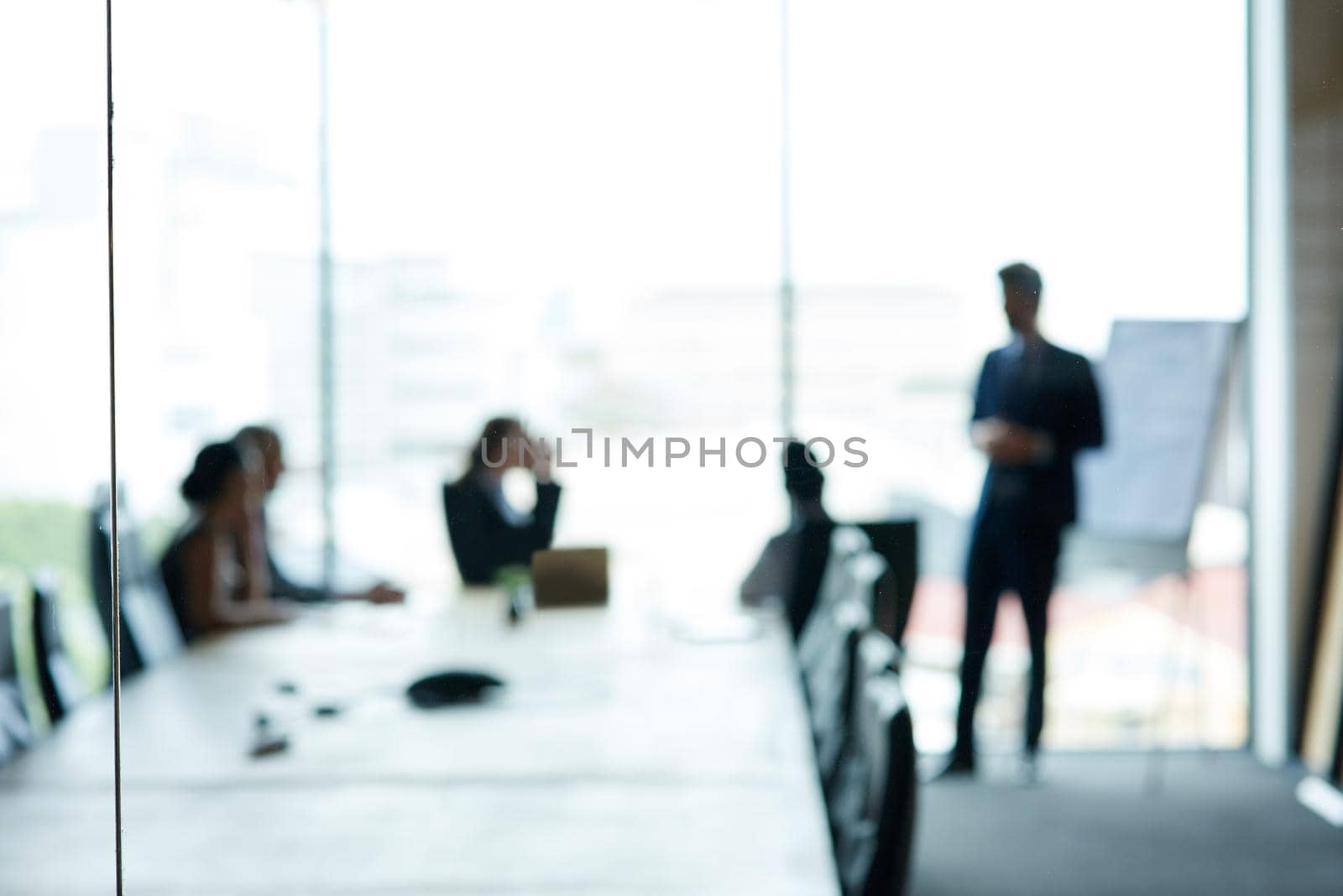 Corporate movers and shakers in action. Shot of a group of executives having a meeting in a boardroom. by YuriArcurs