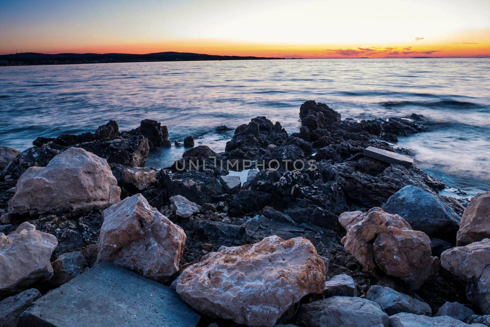 Rocky coastline and blue sky on island Vir, Croatia. Evening sunset with pastel colours of sky.