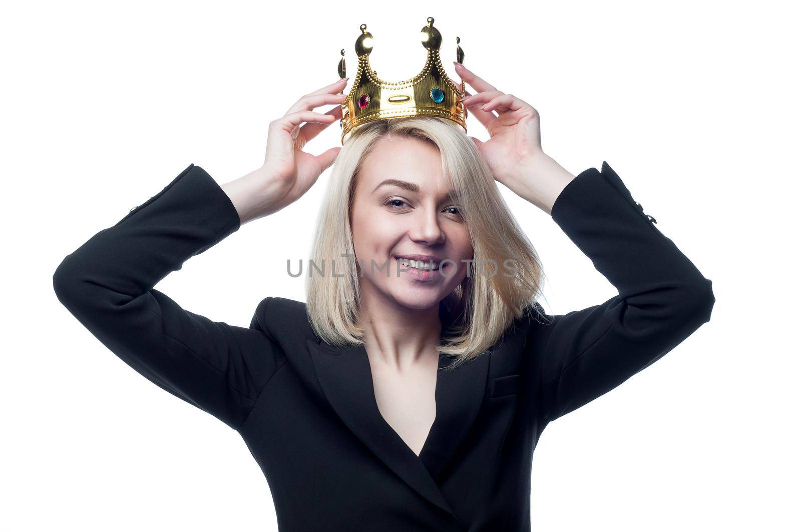 Blond girl with crown on head on white background