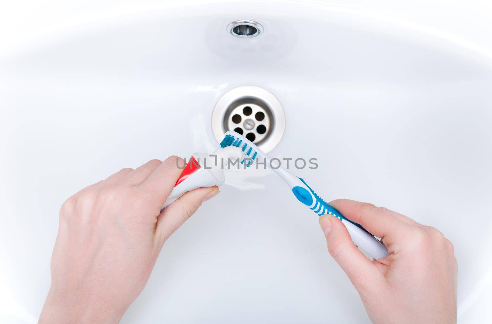 brushing your teeth in the sink with a toothbrush