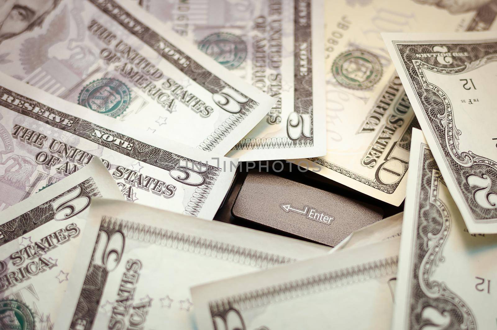 spread out money on a black keyboard by Evgenii_Leontev