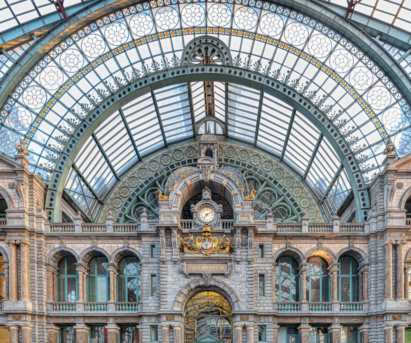 Famous old clock on the facade of the old beautiful railway station in Antwerp