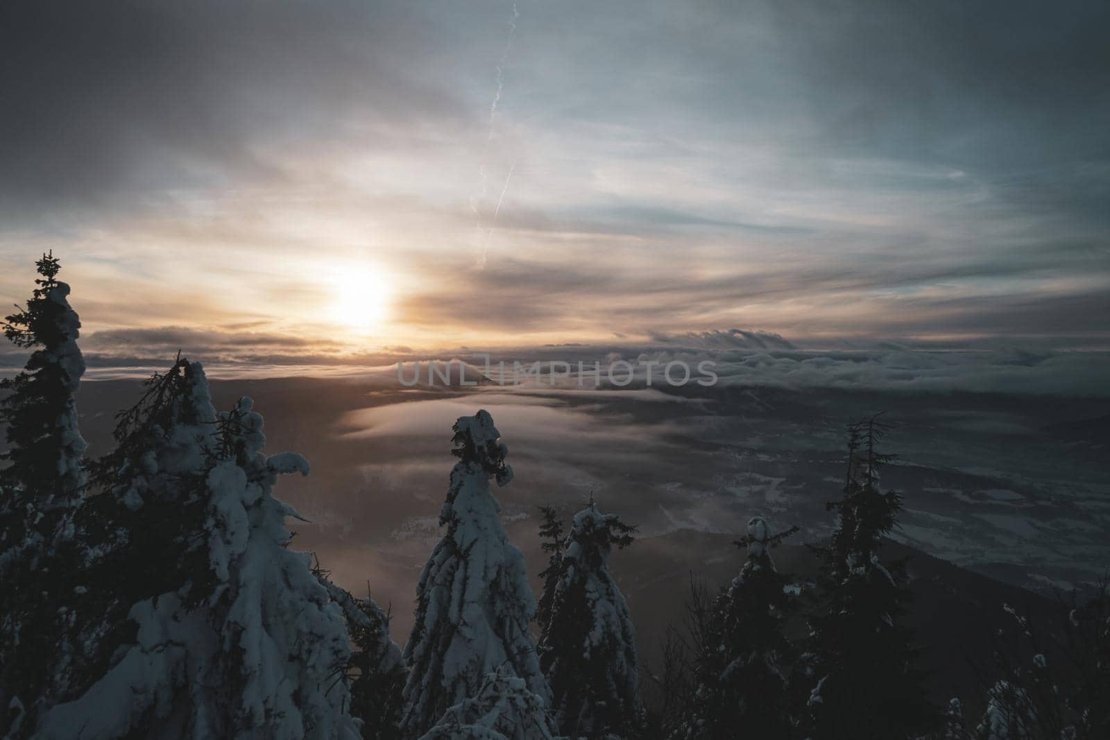 Dramatic Sunset with Frozen Trees and Valley View in Czech Republic from the top of mountain. High quality photo
